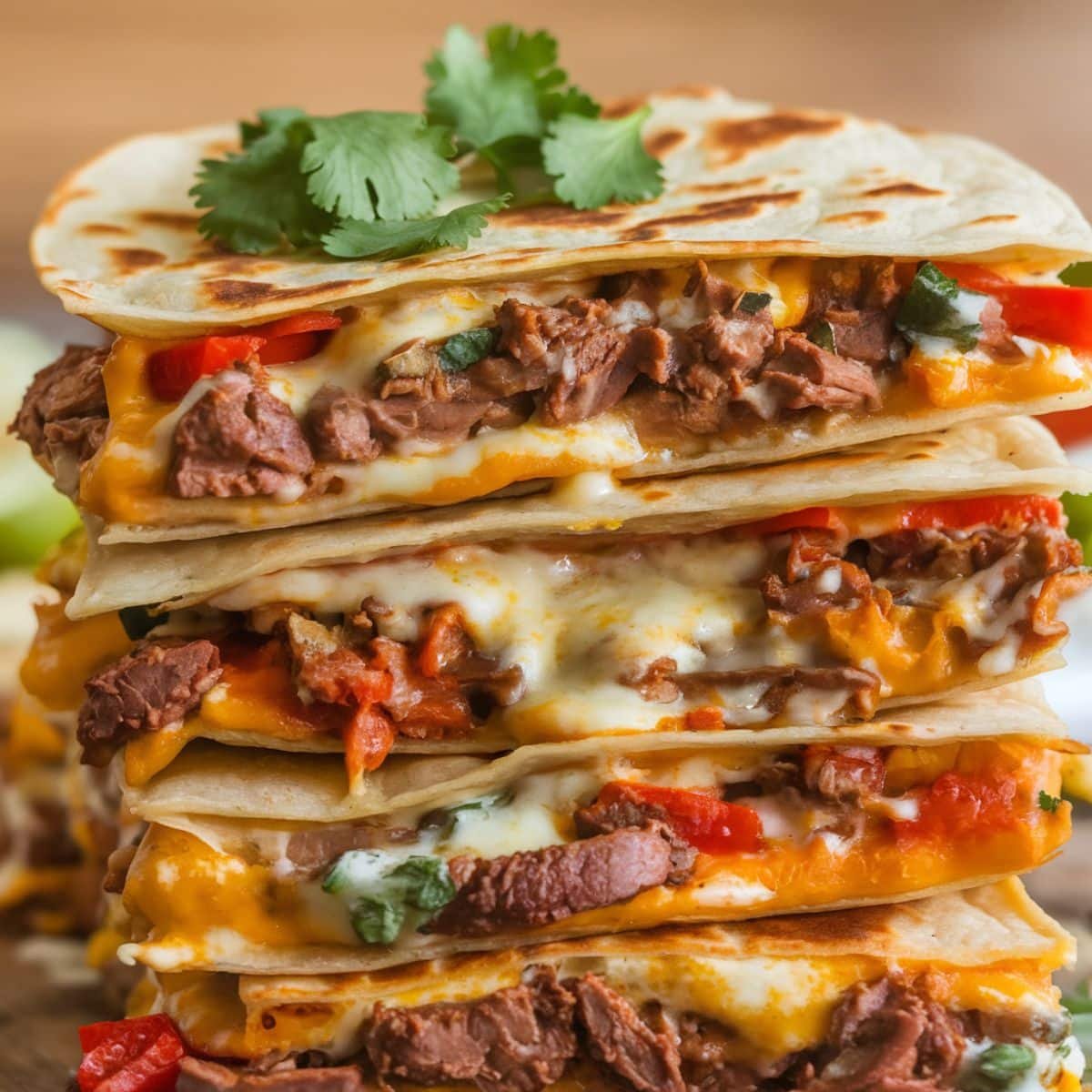 Close-up of a stack of mouthwatering Steak Quesadillas filled with seasoned steak, gooey melted cheese, and vibrant bell peppers, perfect for the ultimate Steak Quesadilla Recipe.