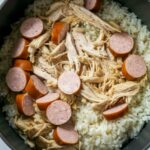 A close-up of Chicken Bog Recipe, a traditional Southern one-pot dish, featuring tender shredded chicken, smoked sausage slices, and seasoned rice cooked together in a flavorful broth. This comforting and hearty Carolina-inspired recipe is known for its rich taste and satisfying texture.