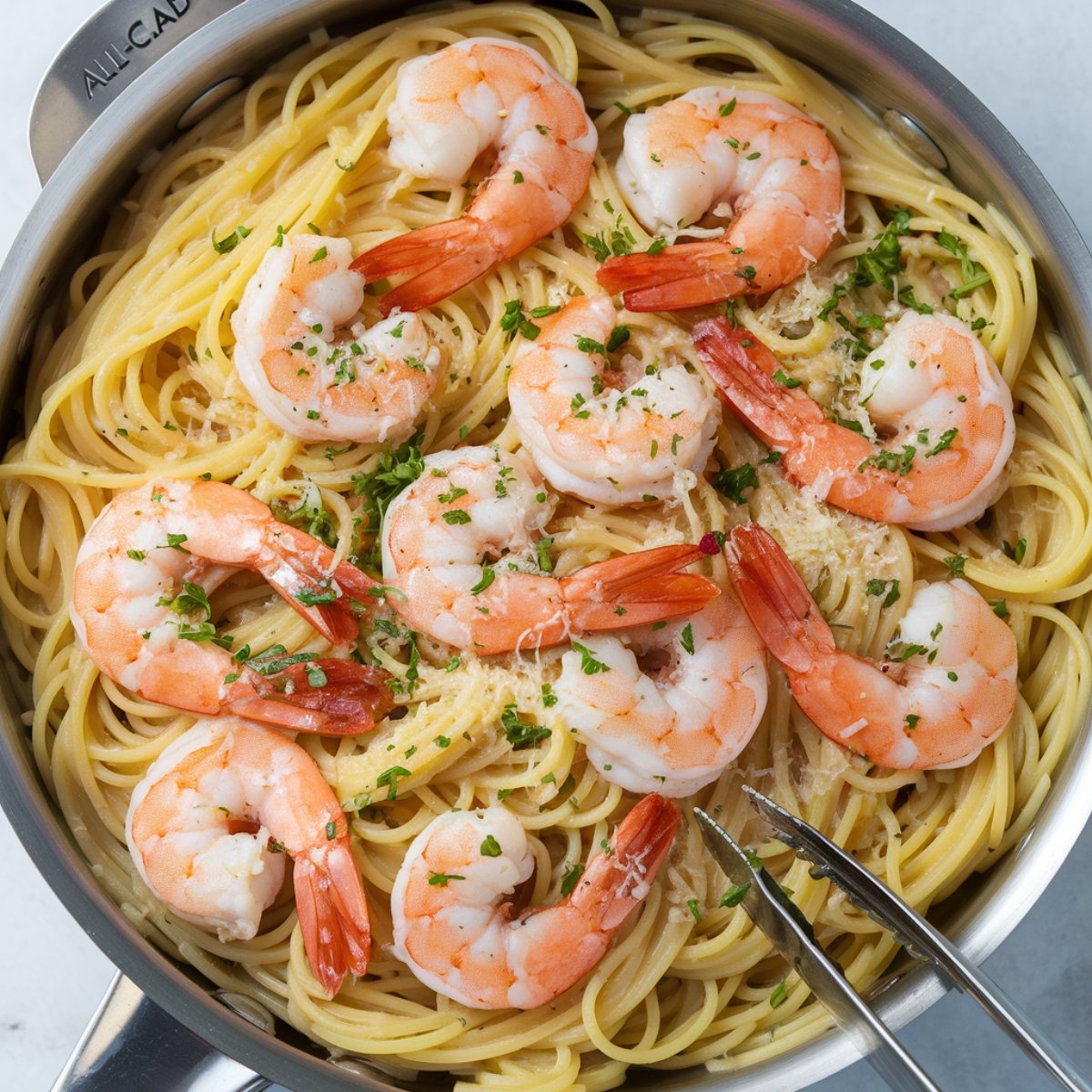 A delicious pan of Garlic Butter Shrimp and Pasta, featuring tender shrimp sautéed in a rich garlic butter sauce, tossed with al dente spaghetti, and garnished with fresh parsley and grated Parmesan. This flavorful dish is a perfect combination of creamy, buttery goodness with a hint of citrus and herbs.