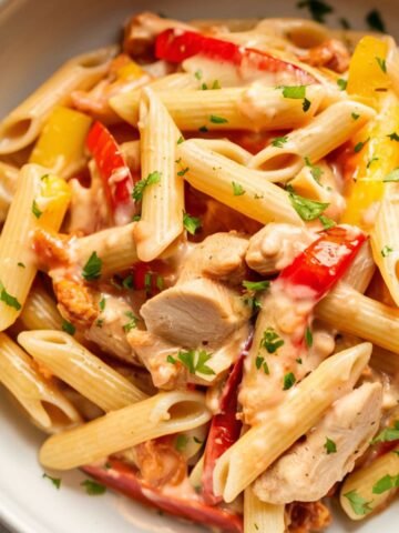 Delicious Chicken Fajita Pasta Recipe made with tender chicken, sautéed bell peppers, and penne pasta tossed in a creamy, flavorful fajita sauce. This easy one-pan Tex-Mex pasta is the perfect comfort food for a quick and satisfying meal!