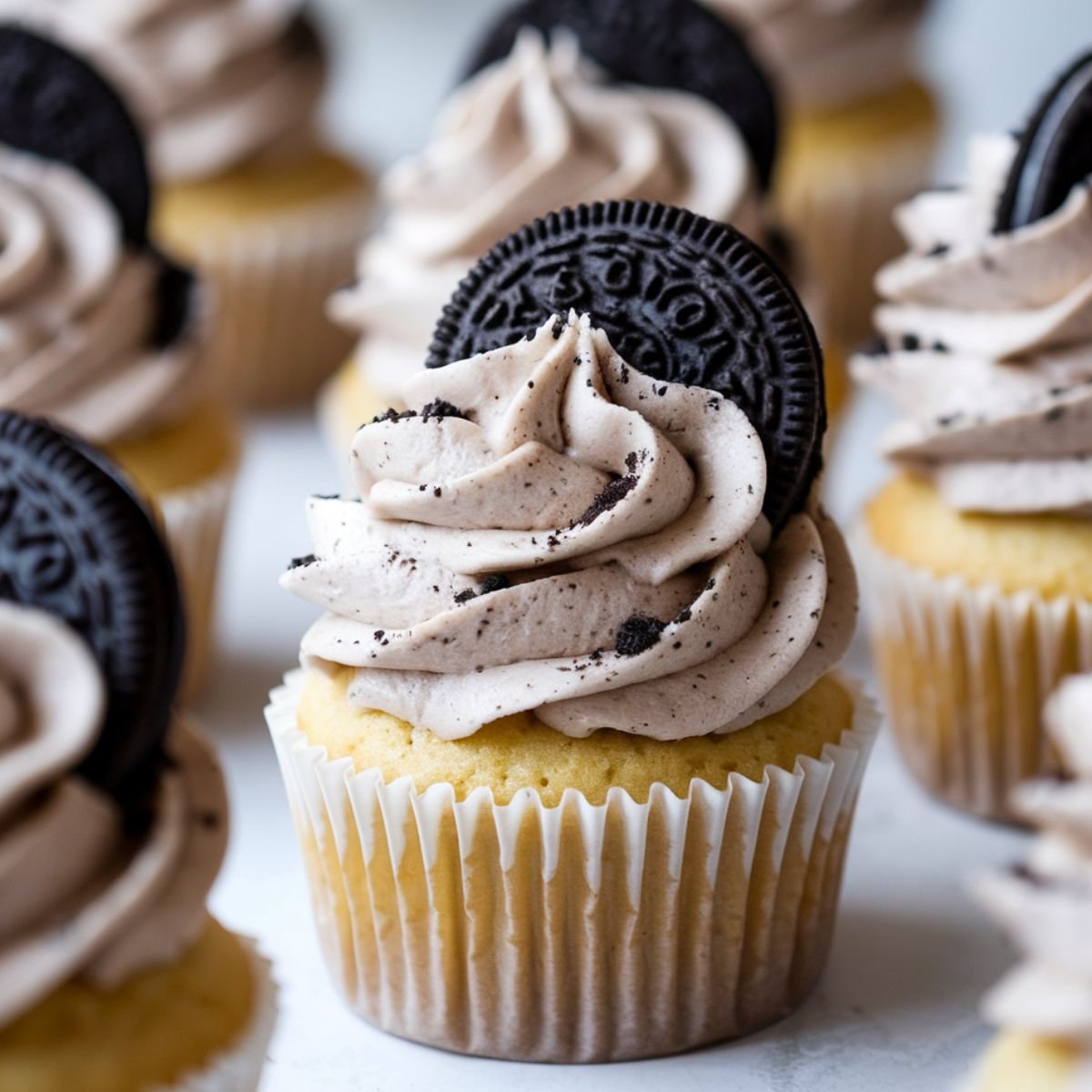 Homemade Oreo Cupcake Recipe with Vanilla Cake and Cookies & Cream Frosting – Moist Cupcakes Topped with Oreo Buttercream and a Crunchy Oreo Cookie.