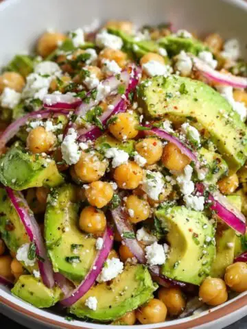 Chickpea Feta Avocado Salad with red onion and herbs tossed in a lemon-herb dressing.