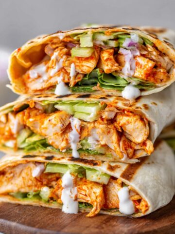 Homemade Buffalo Chicken Wraps filled with shredded chicken, lettuce, celery, and a drizzle of ranch dressing.
