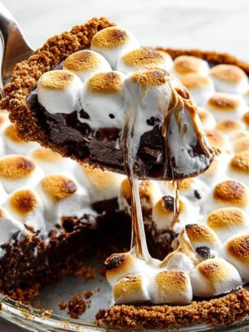 Homemade S'mores Brownie Pie with toasted marshmallows, gooey chocolate filling, and a graham cracker crust.