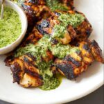 Peruvian Chicken with Green Sauce topped with a vibrant green sauce, made with fresh herbs, garlic, and lime.