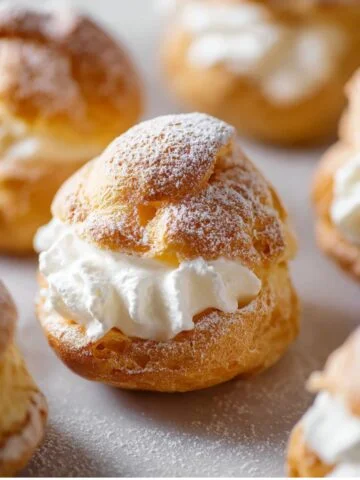 Choux Pastry with a fluffy whipped cream filling, dusted lightly with powdered sugar.