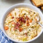Bowl of creamy Crack Chicken Noodle Soup with noodles, bacon, and vegetables