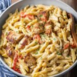 Creamy Cajun chicken pasta with penne, bell peppers, and parsley served in a bowl.
