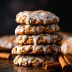 Stack of Iced Gingerbread Oatmeal Cookies drizzled with cinnamon glaze and sprinkled with spice.