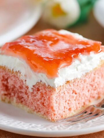 Slice of Hawaiian Guava Cake with cream and jelly topping.