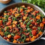 A colorful Sweet Potato Black Bean Skillet, black beans, tomatoes, and kale, creating a flavorful and hearty vegetable dish.